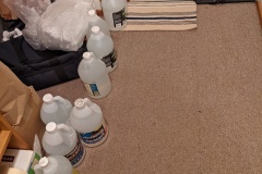 Home - water bottles lined up in the hallway