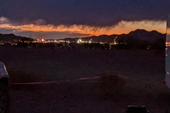 Sunset from Toyota group site - lights of Quartzsite in distance, with rain coming.