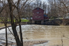 View of mill across the river, small dam on left