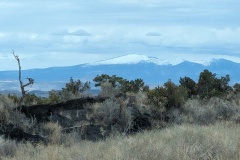 Lava beds in foreground, snow-capped mountain in rear