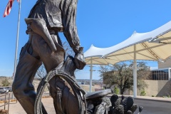Cowboy with his saddle, looks like he's hot