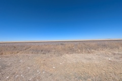 Railroad tracks across the undeveloped plains