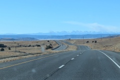 Rolling Hills, not just plains, with mountains and forest in the distance