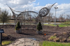 “The Unexpected Us” installation featuring a massive woven willow stick structure shaped like a bird