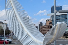 “Taking Flight: Light as a Feather” is a 31-foot-high sculpture resembling a feather floating to the ground