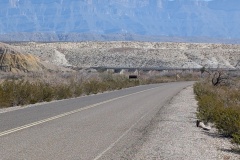 We were traveling near a dry river bed, with white rock formations on the far side